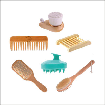 Eco-friendly bath accessory set with bamboo combs, brushes, soap dish, scrubber and massage tool on white background